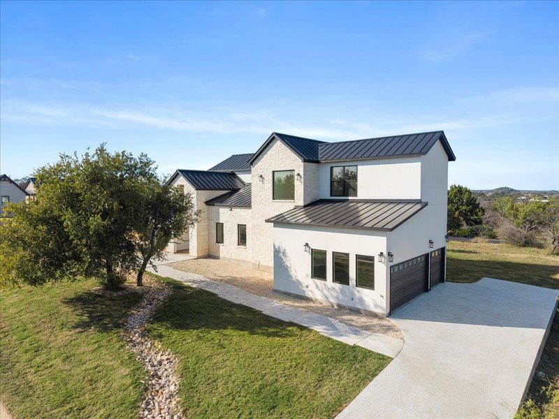 Front exterior of a new home in , Horseshoe Bay, TX, highlighting curb appeal (Image 2). Front exterior of a new home in , Horseshoe Bay, TX, highlighting curb appeal (Image 2).