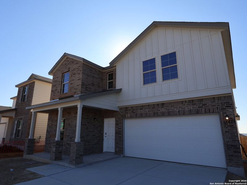 Front exterior of a new home in Hunters Ranch, San Antonio, TX, highlighting curb appeal (Image 17).
