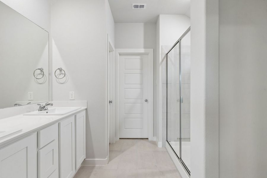 Primary Bathroom in the Oscar home plan by Trophy Signature Homes – REPRESENTATIVE PHOTO