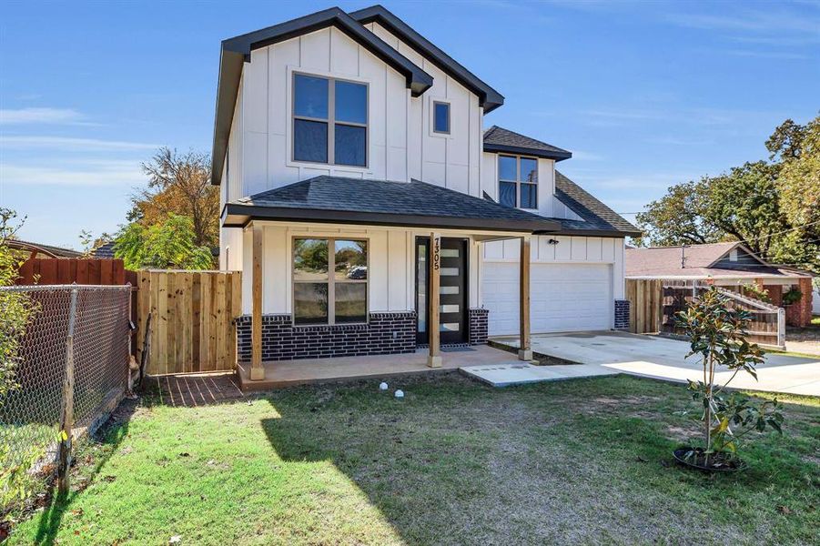 View of front of home with board and batten siding, roof with shingles, driveway, and a garage