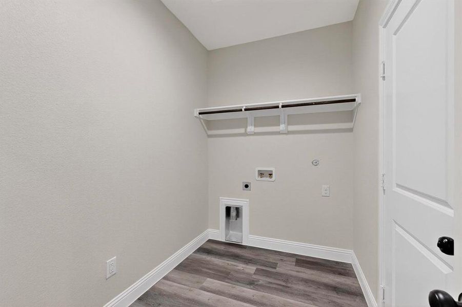 Laundry room with wood finished floors, electric dryer hookup, hookup for a washing machine, and hookup for a gas dryer Laundry room with wood finished floors, electric dryer hookup, hookup for a washing machine, and hookup for a gas dryer