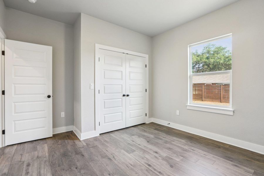 Unfurnished bedroom with a closet and light wood finished floors