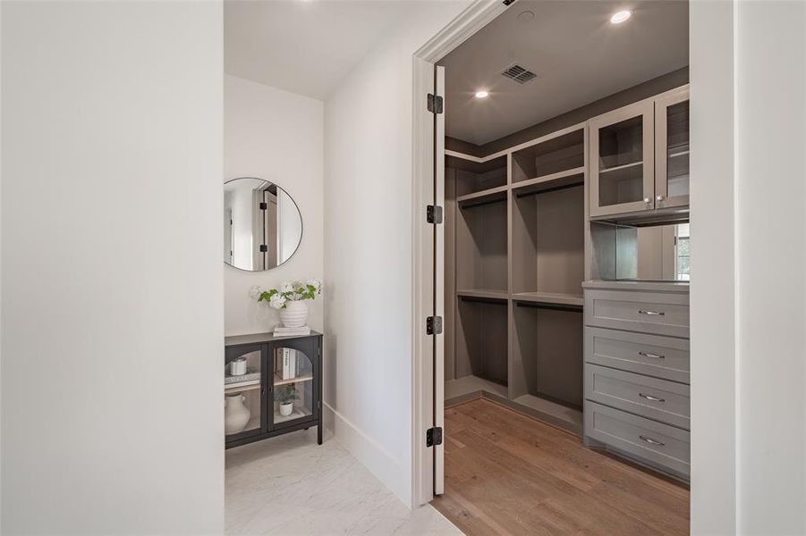 Spacious closet with light hardwood / wood-style floors