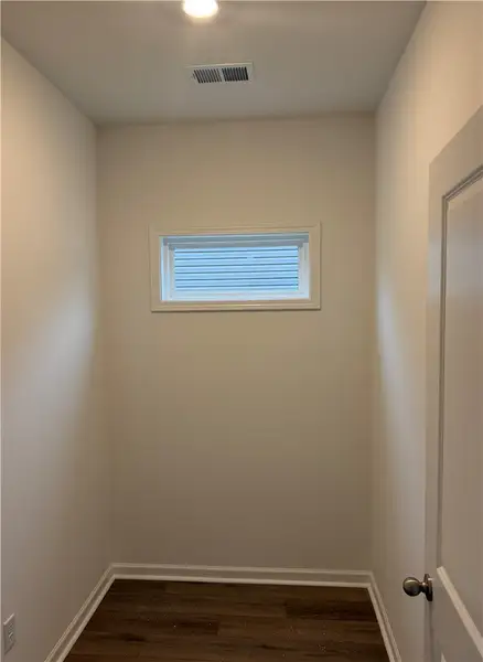 Natural light pours through a high transom window
