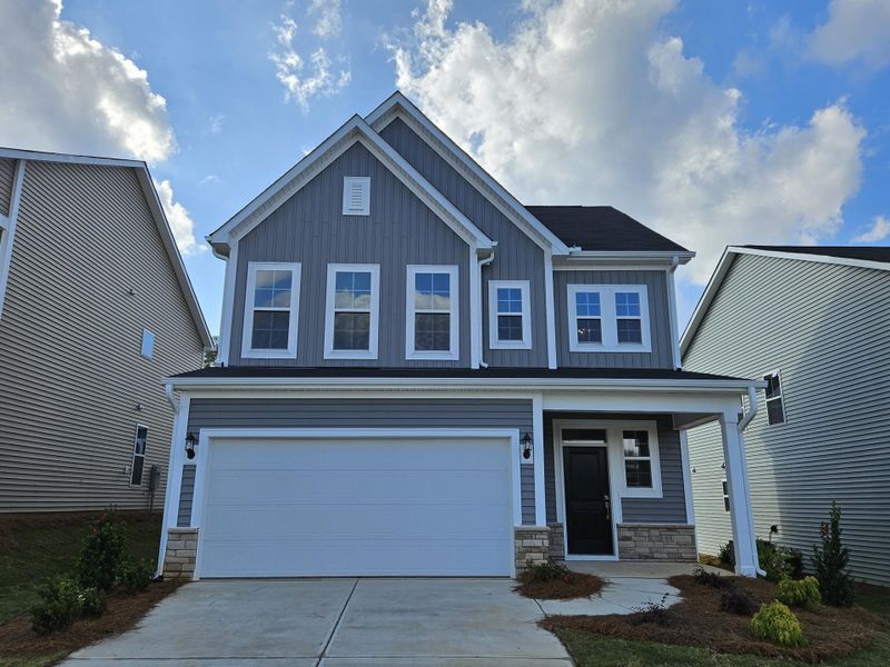 Front exterior of a new home in Renaissance at White Oak, Garner, NC, highlighting curb appeal (Image 1).