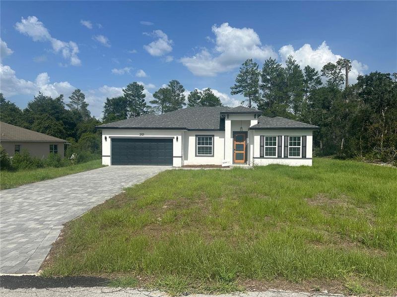 Front exterior of a new home in , Ocala, FL, highlighting curb appeal (Image 1).
