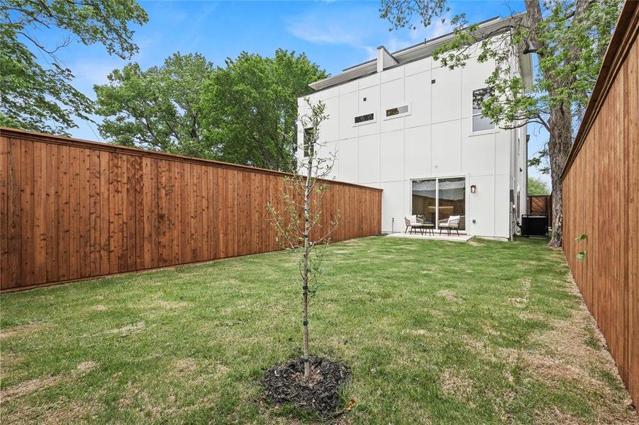 View of yard featuring a fenced backyard, a patio, and cooling unit