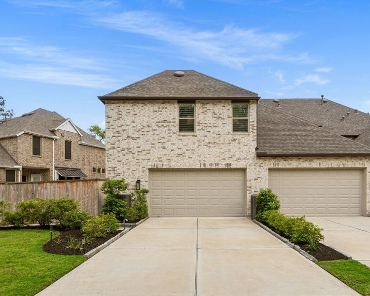 Two car oversized garage with an oversized driveway - you an fit at least four cars in the driveway - and there is also abundant yard space to the left of the driveway.