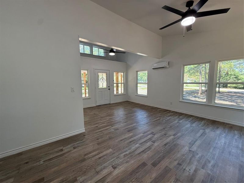 Entrance foyer featuring dark wood-style floors, a high ceiling, and a ceiling fan
