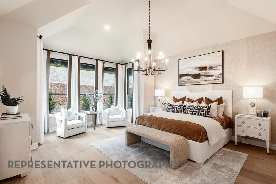 Bedroom featuring a chandelier, wood finished floors, and vaulted ceiling Bedroom featuring a chandelier, wood finished floors, and vaulted ceiling