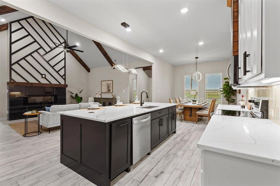 Kitchen with light stone counters, white cabinetry, decorative light fixtures, appliances with stainless steel finishes, and recessed lighting