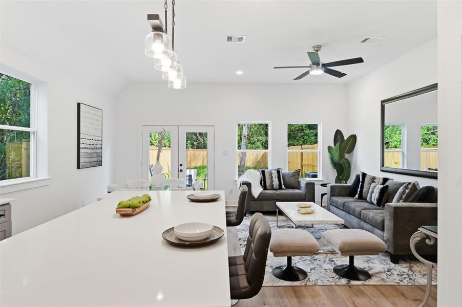Open concept kitchen, dining and living room, with lots of natural light.