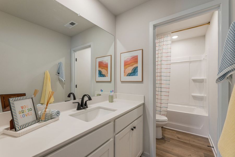 A bathroom with a sink and a shower.