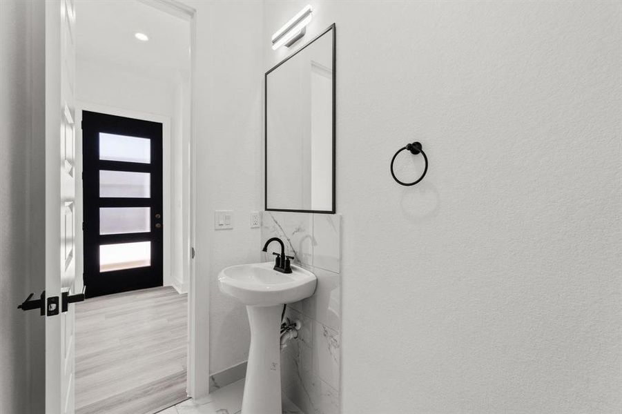 Downstairs guest bath (half-bath) with pedestal sink