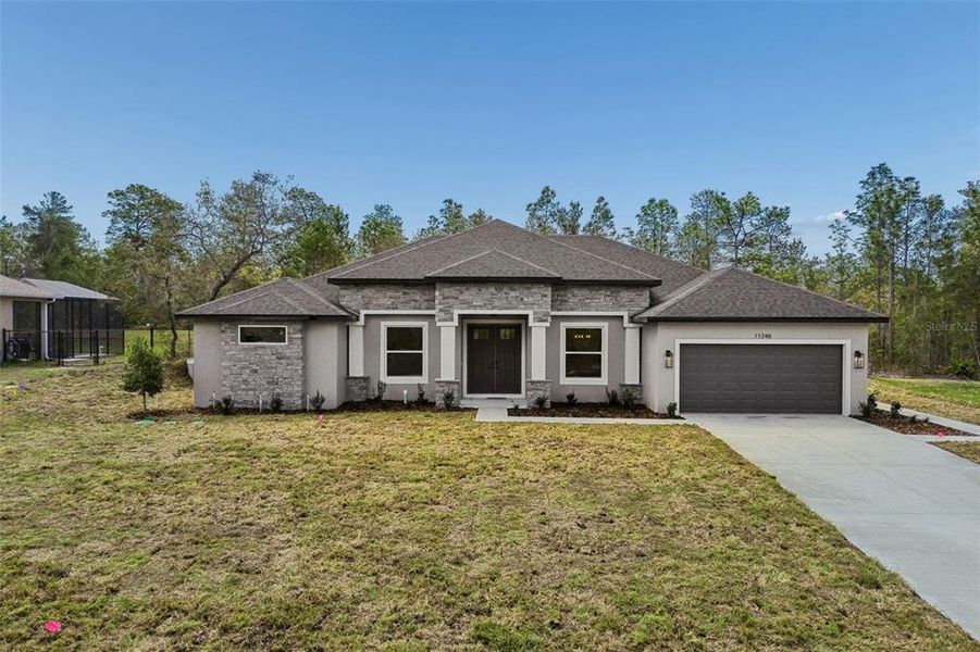 Front exterior of a new home in , Weeki Wachee, FL, highlighting curb appeal (Image 31).