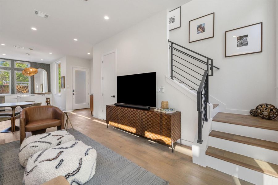 Living room featuring light wood finished floors and recessed lighting