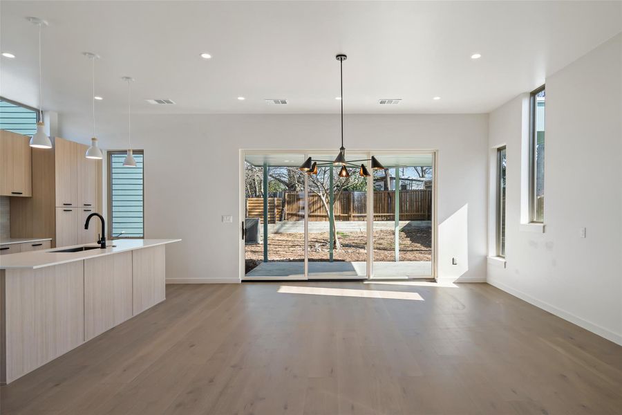 Dining space with light wood-type flooring, visible vents, and recessed lighting