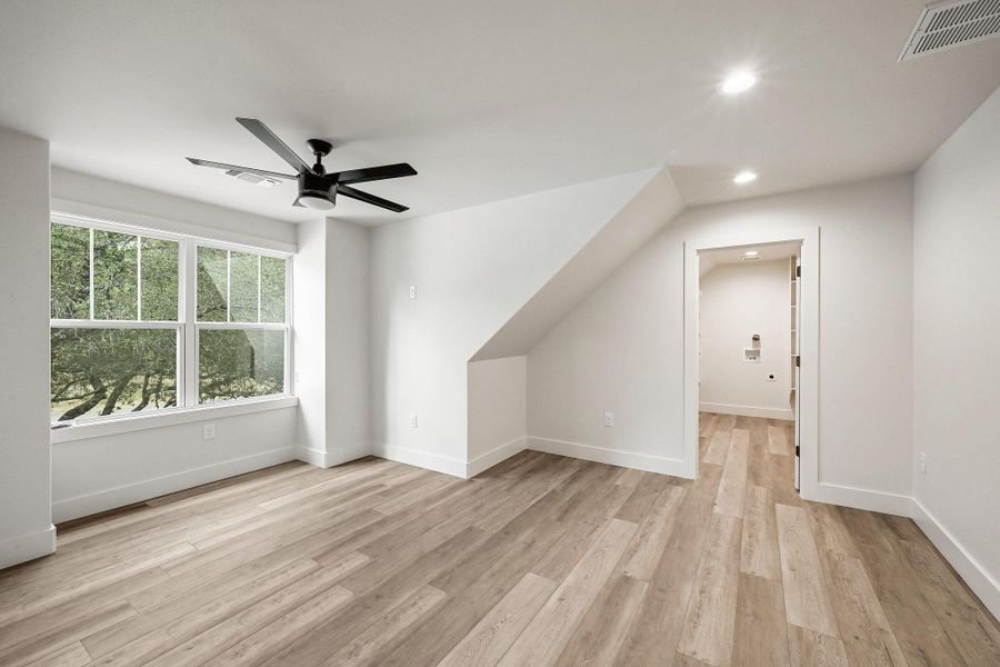 Spacious upper-level suite with generous natural light, durable wood-look flooring, and private bath access. Spacious upper-level suite with generous natural light, durable wood-look flooring, and private bath access.