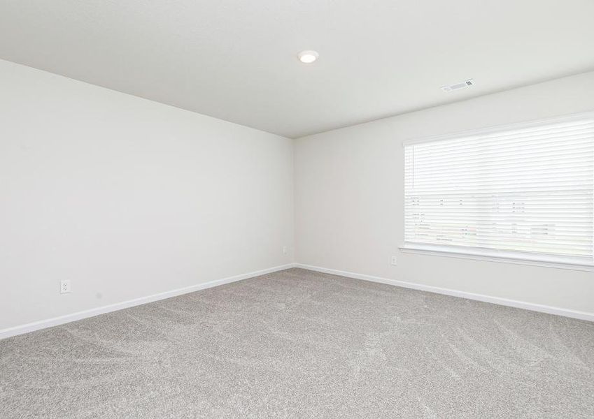 This bedroom in the Lincoln includes a massive window that lets in an incredible amount of natural light