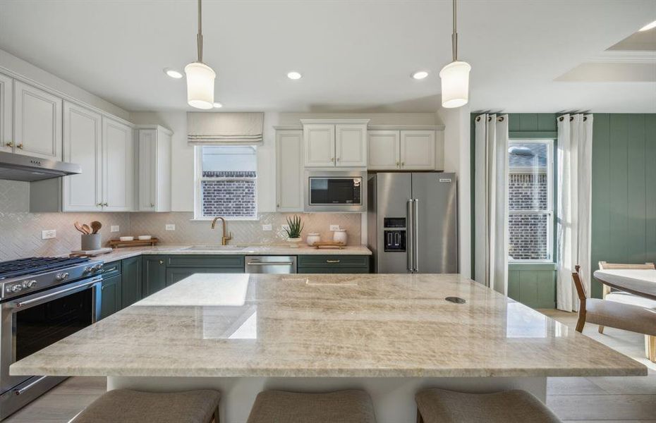 Bright kitchen with an expansive center island perfect for gatherings *Model representation Bright kitchen with an expansive center island perfect for gatherings *Model representation