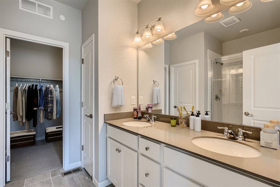 A bathroom with a large mirror. A bathroom with a large mirror.