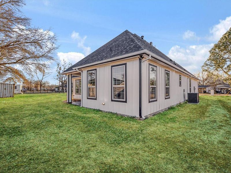 View of side of home with roof with shingles and a cooling unit View of side of home with roof with shingles and a cooling unit