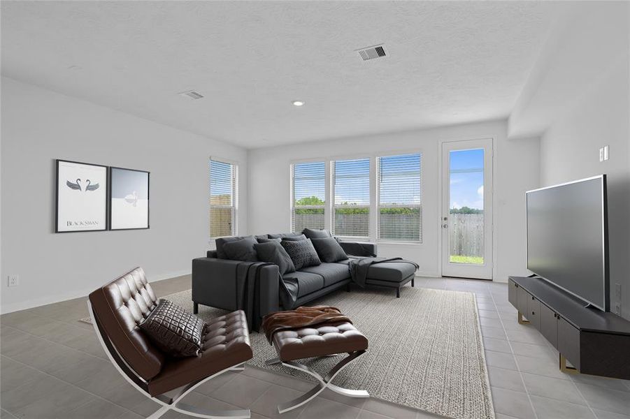 Gather the family and guests together in your lovely living room! Featuring high ceilings, recessed lighting, ceiling fan, custom paint, gorgeous tile floors and large windows that provide plenty of natural lighting throughout the day.