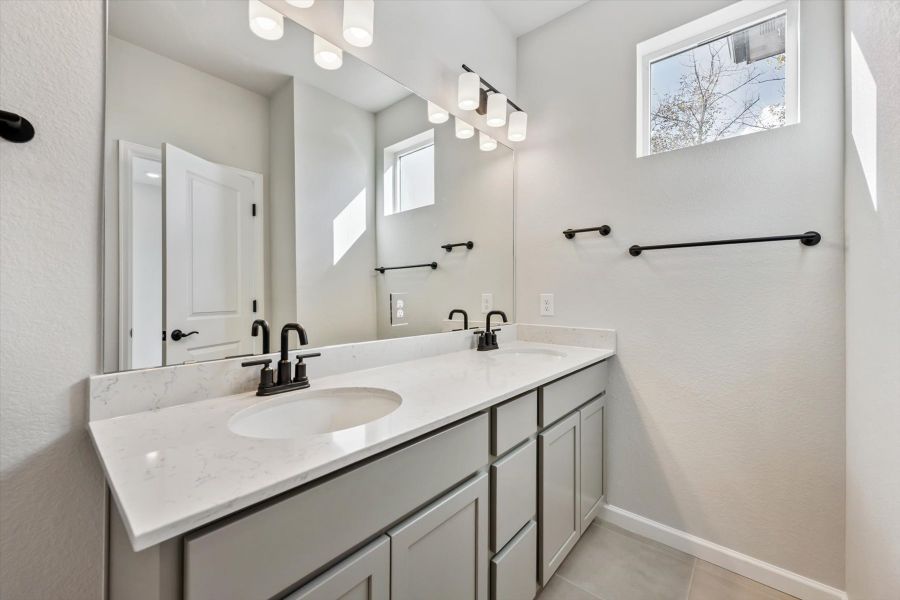 A bathroom with a large mirror. A bathroom with a large mirror.