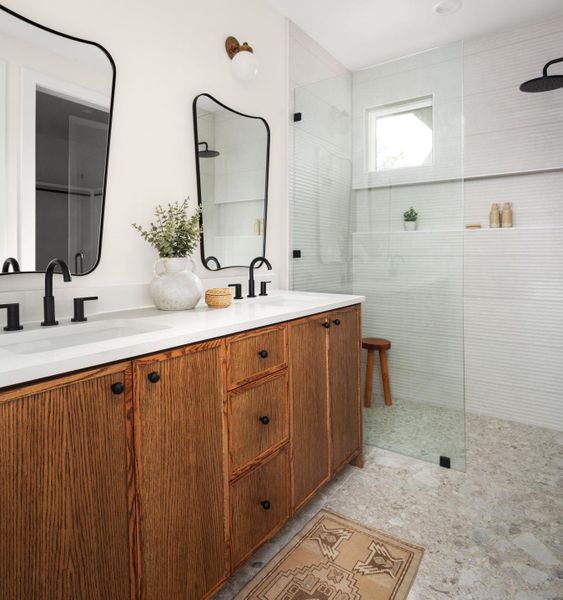 Full bathroom with walk in shower and double vanity