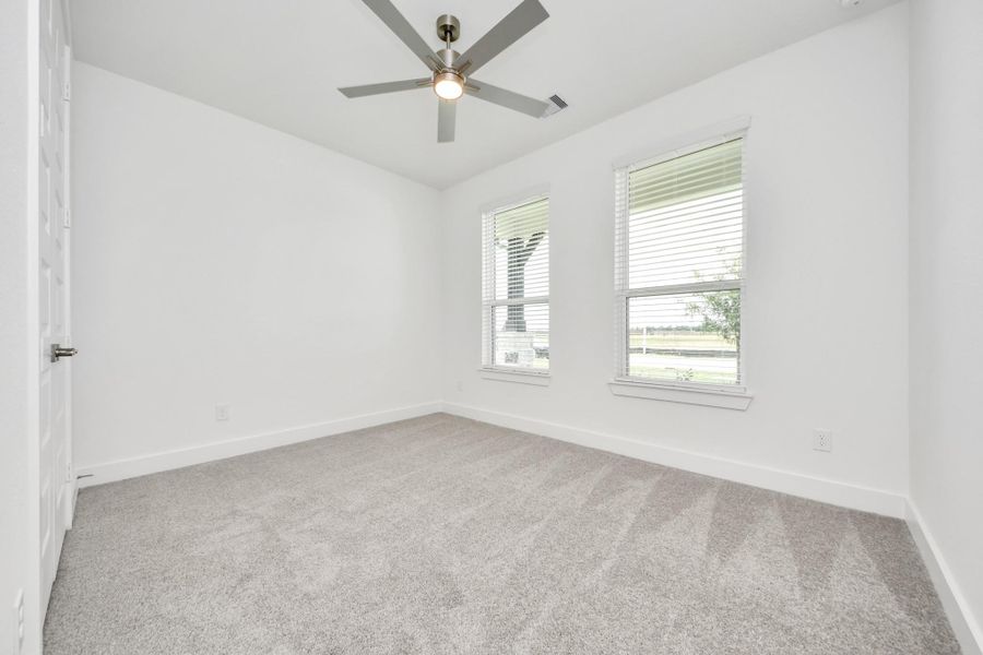 Secondary bedroom features plush carpeting, large windows that let in plenty of natural light, bright paint, and spacious closets. Secondary bedroom features plush carpeting, large windows that let in plenty of natural light, bright paint, and spacious closets.