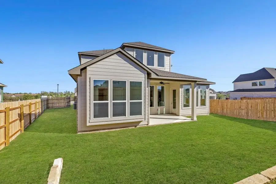 Rear view of house with a ceiling fan, a patio, a fenced backyard, and roof with shingles Rear view of house with a ceiling fan, a patio, a fenced backyard, and roof with shingles