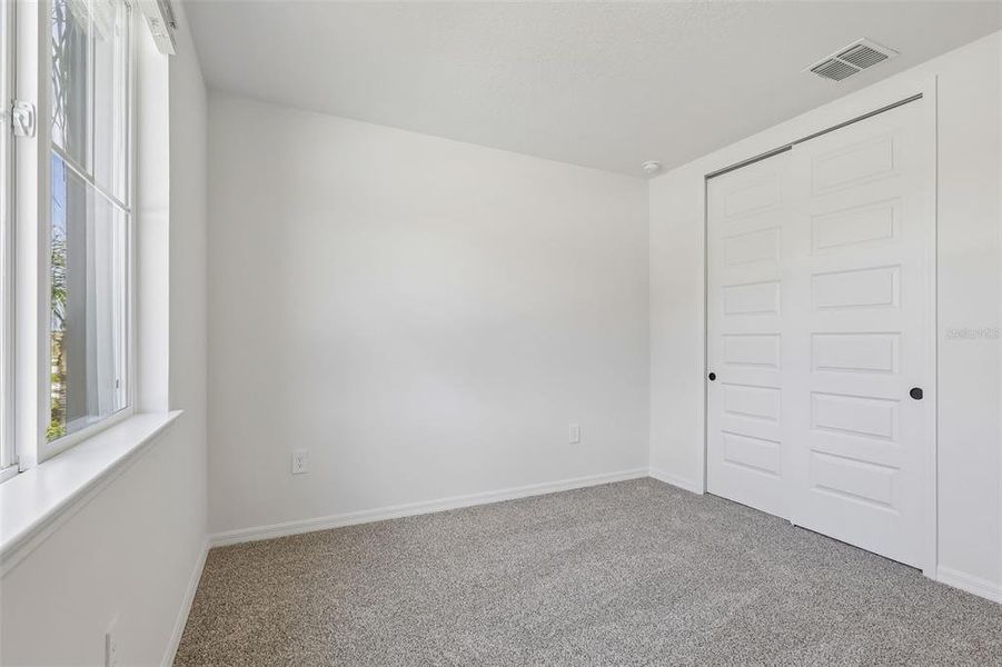 Spacious, unfurnished interior of a new home in The Grove at Stuart Crossing - Signature Series, Bartow (Image 25).
