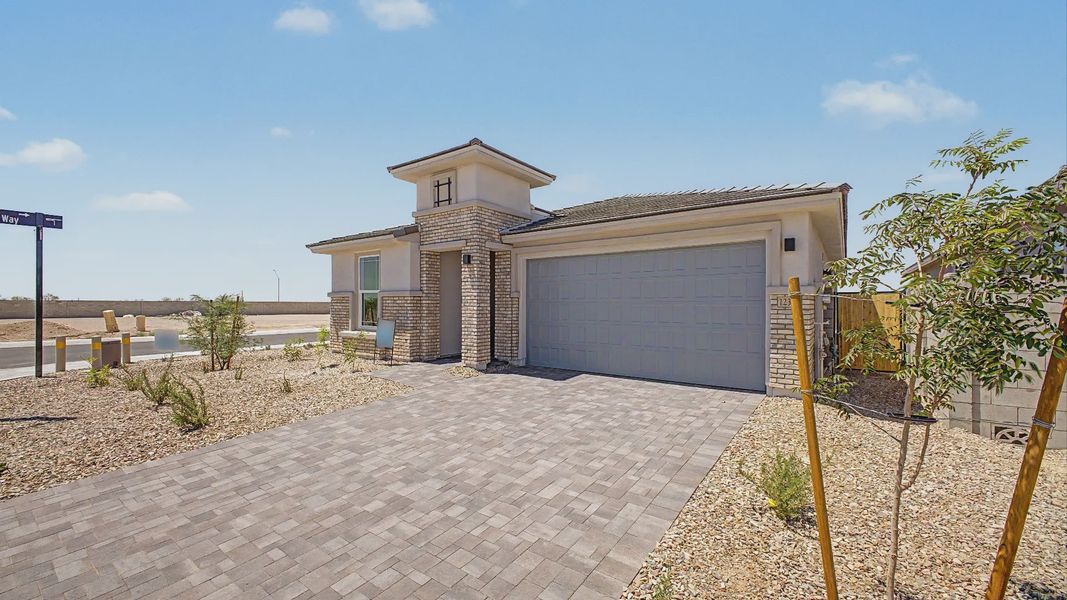 Front exterior of a new home in Teravalis, Buckeye, AZ, highlighting curb appeal (Image 2). Front exterior of a new home in Teravalis, Buckeye, AZ, highlighting curb appeal (Image 2).