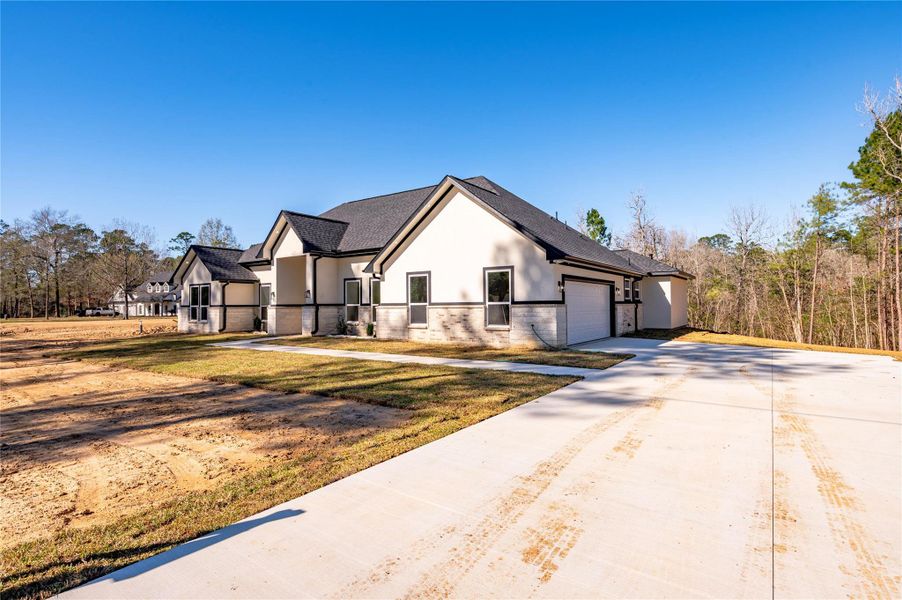 Front exterior of a new home in , Dayton, TX, highlighting curb appeal (Image 24).