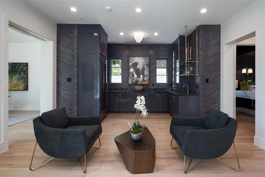 Living room with sink and light hardwood / wood-style floors