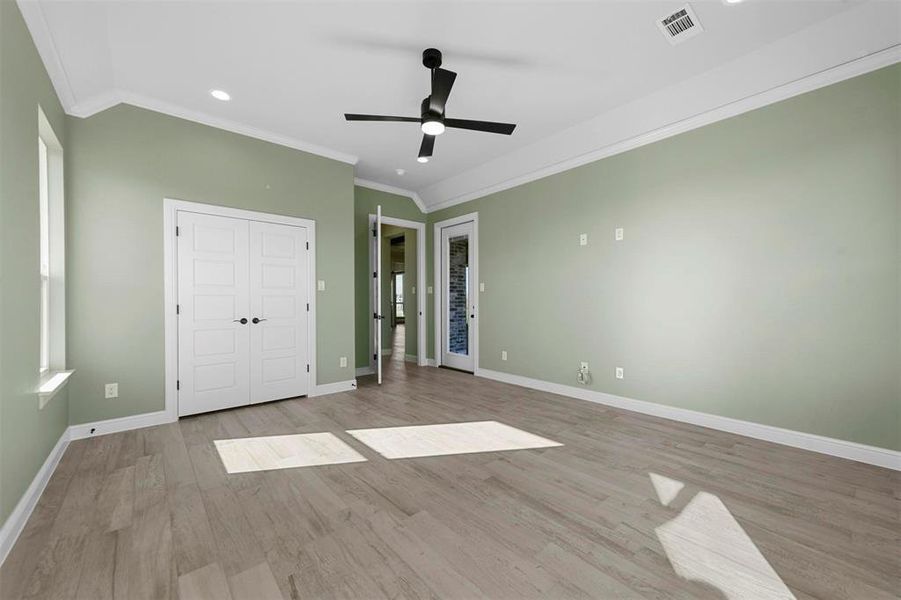 Second living or 4th bedroom featuring ceiling fan, light hardwood / wood-style flooring, and crown molding