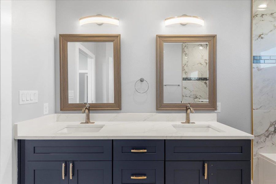 Full bath featuring double vanity, a bath, and a marble finish shower Full bath featuring double vanity, a bath, and a marble finish shower