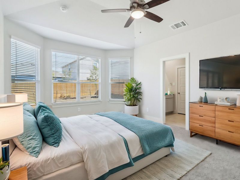 Virtually staged primary suite in the San Saba floorplan at a Meritage Homes community.