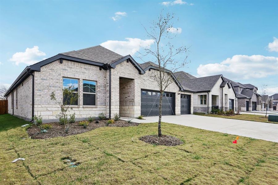 Front exterior of a new home in Parks at Foster Crossing - Premier Series, Anna, TX, highlighting curb appeal (Image 24). Front exterior of a new home in Parks at Foster Crossing - Premier Series, Anna, TX, highlighting curb appeal (Image 24).