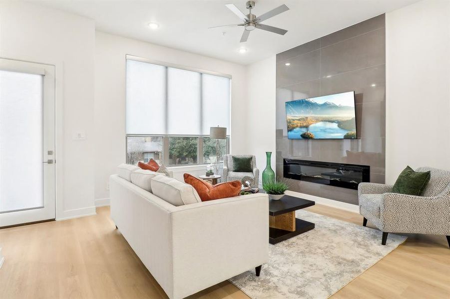 Living area with light wood-style floors, recessed lighting, ceiling fan, and baseboards