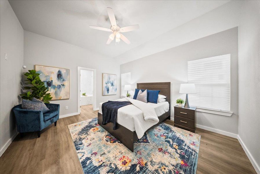 Bedroom featuring wood finished floors, a ceiling fan, and connected bathroom Bedroom featuring wood finished floors, a ceiling fan, and connected bathroom
