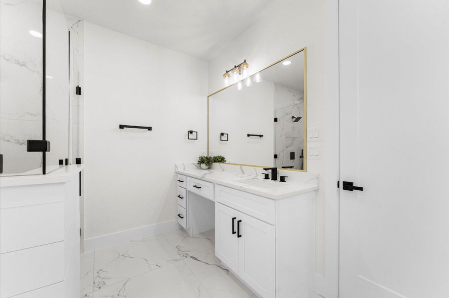 Spa-inspired bath with walk-in shower, soaking tub, double vanities, quartz counters, and luxury finishes. Spa-inspired bath with walk-in shower, soaking tub, double vanities, quartz counters, and luxury finishes.
