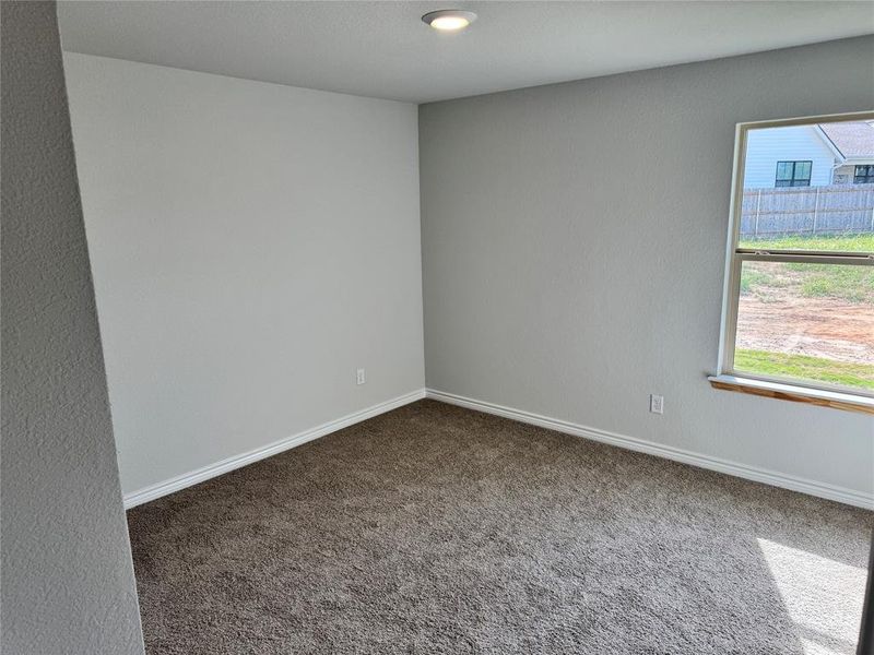 Carpeted empty room with baseboards and recessed lighting