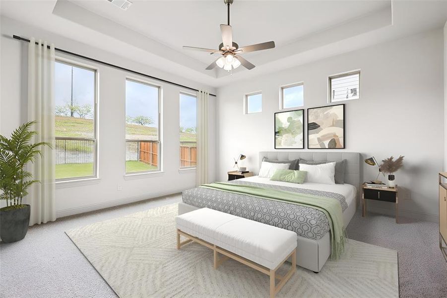 Bedroom with ceiling fan, light colored carpet, a raised ceiling, and multiple windows