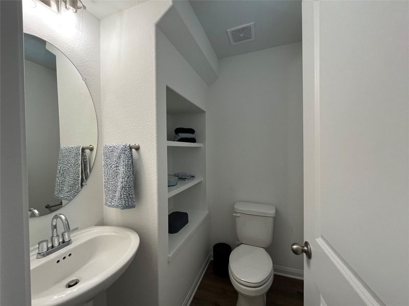 For demonstration purposes only. This will be the same interior layout. Colors can vary. Half guest bath off entry with deep decorative shelving