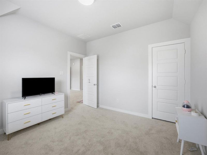 Bedroom featuring light carpet and baseboards