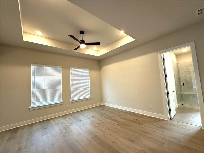 Private primary suite at the back of the home provides a peaceful retreat.  Enjoy quiet mornings and peaceful evenings in a space designed for rest and renewal, complete with a spacious walk-in closet and a luxurious en-suite bath featuring dual vanities and a relaxing layout