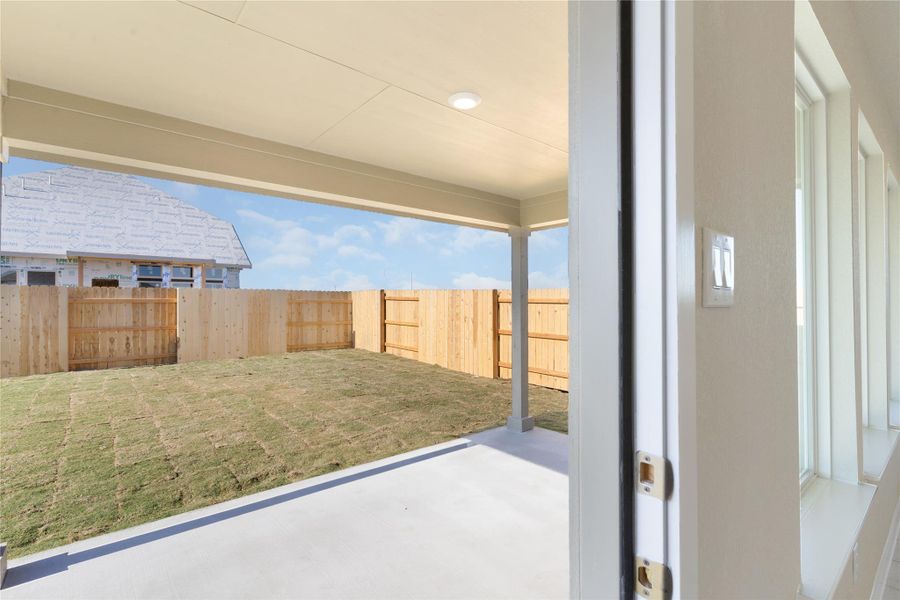 Fenced backyard with a patio area