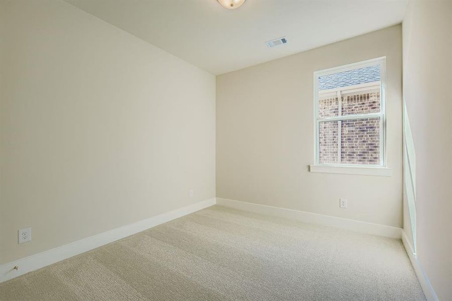 Spare room featuring carpet floors and baseboards