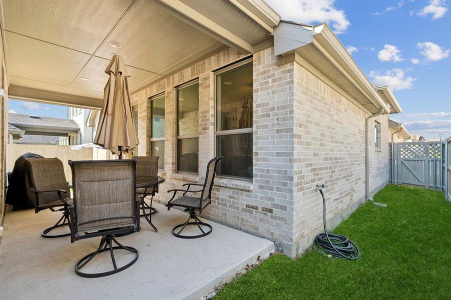View of patio / terrace with outdoor dining space and a gate View of patio / terrace with outdoor dining space and a gate